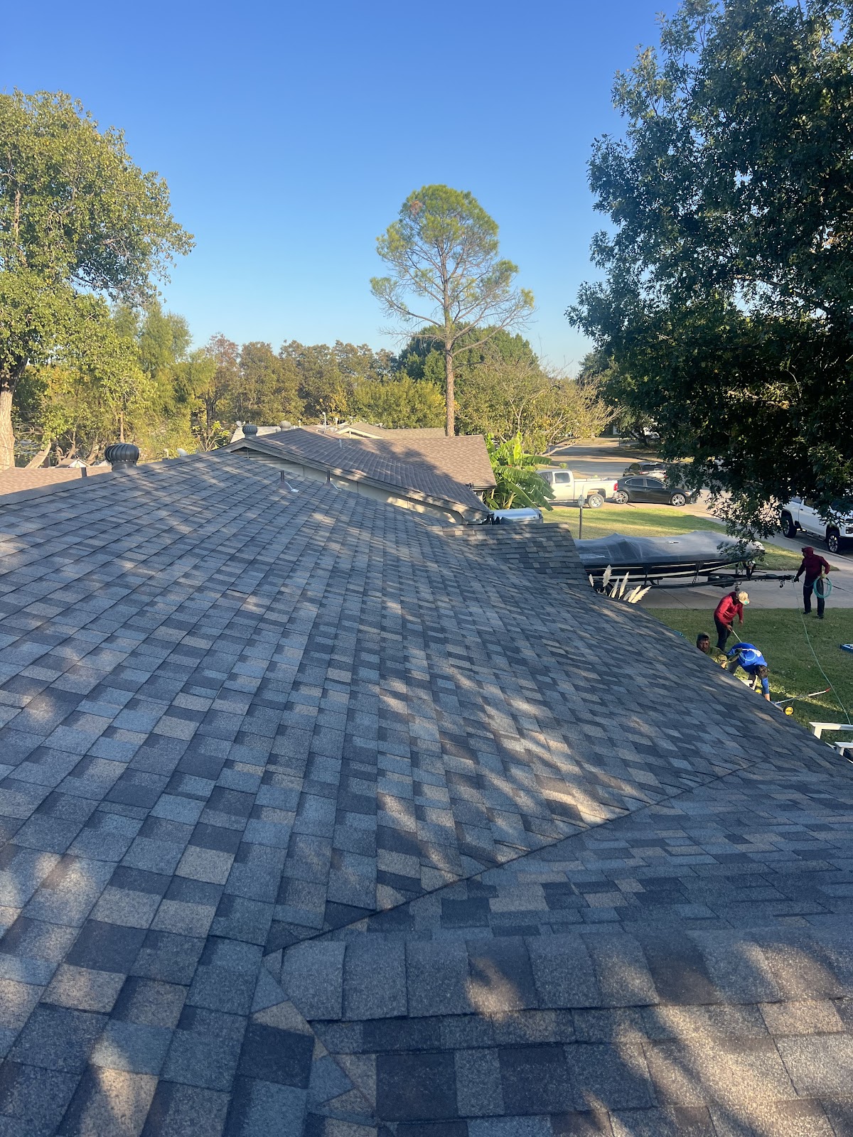 Aerial view of completed dark shingle roof